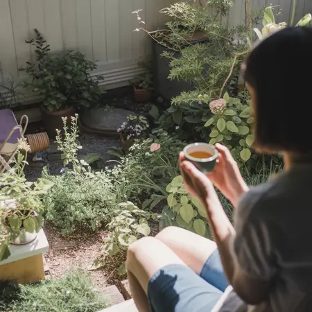 Person enjoying tea in garden